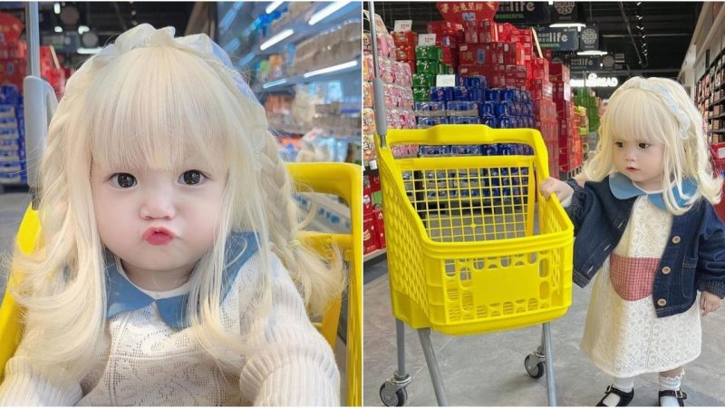 “The baby with beautiful platinum hair is breathtakingly attractive, attracting shoppers at the mall”